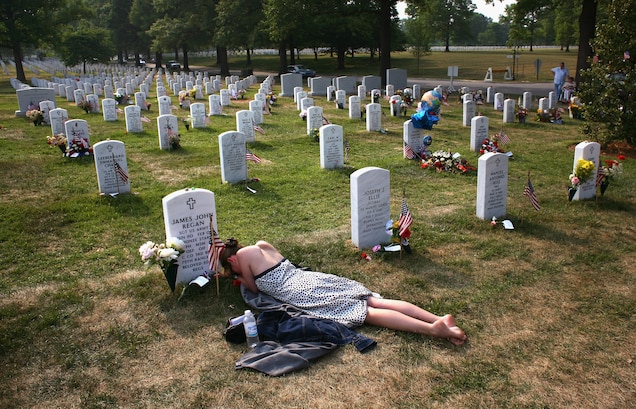 alive-girl-lies-in-the-cemetery, PHOTOGRAPH BY JOHN MOORE, GETTY