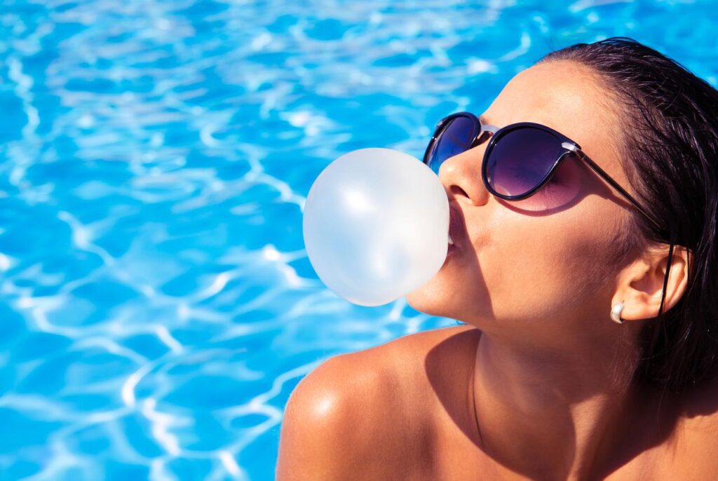 A young-girl-inflated-a-bubble-gum-balloon-in-the-pool