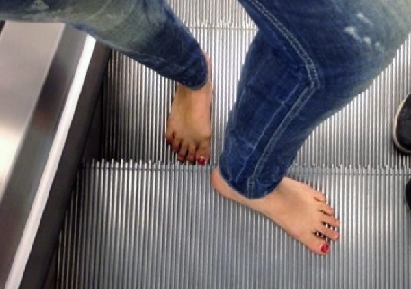 Woman-riding-escalator