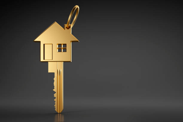 Golden-house-shaped-key-on-dark-background